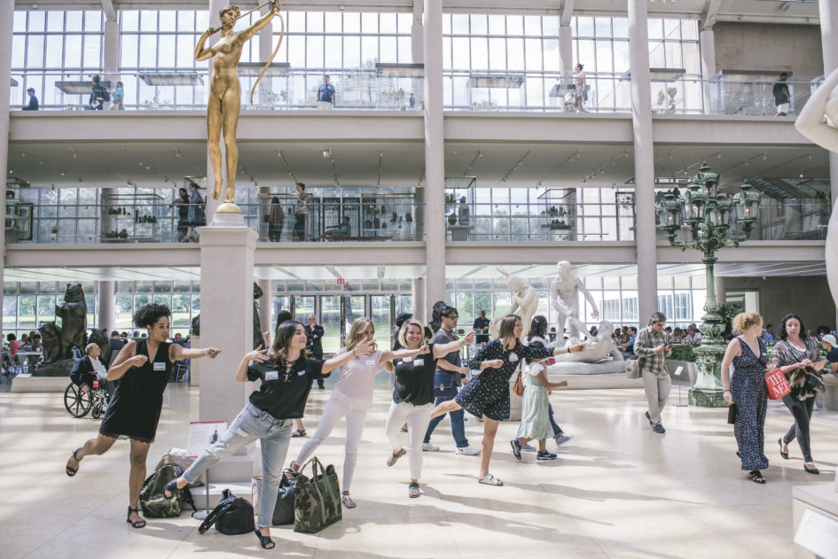 A team poses to mimic the art at the Met.