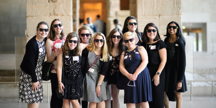 A group of nine women wearing shades at the museum. So cool.